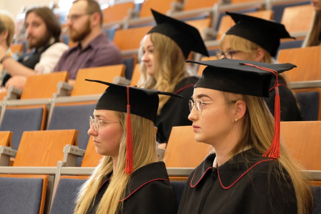 studenci w togach na auli siedzą